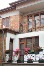 Photo of Exterior of beautiful residential building with balcony and flowers