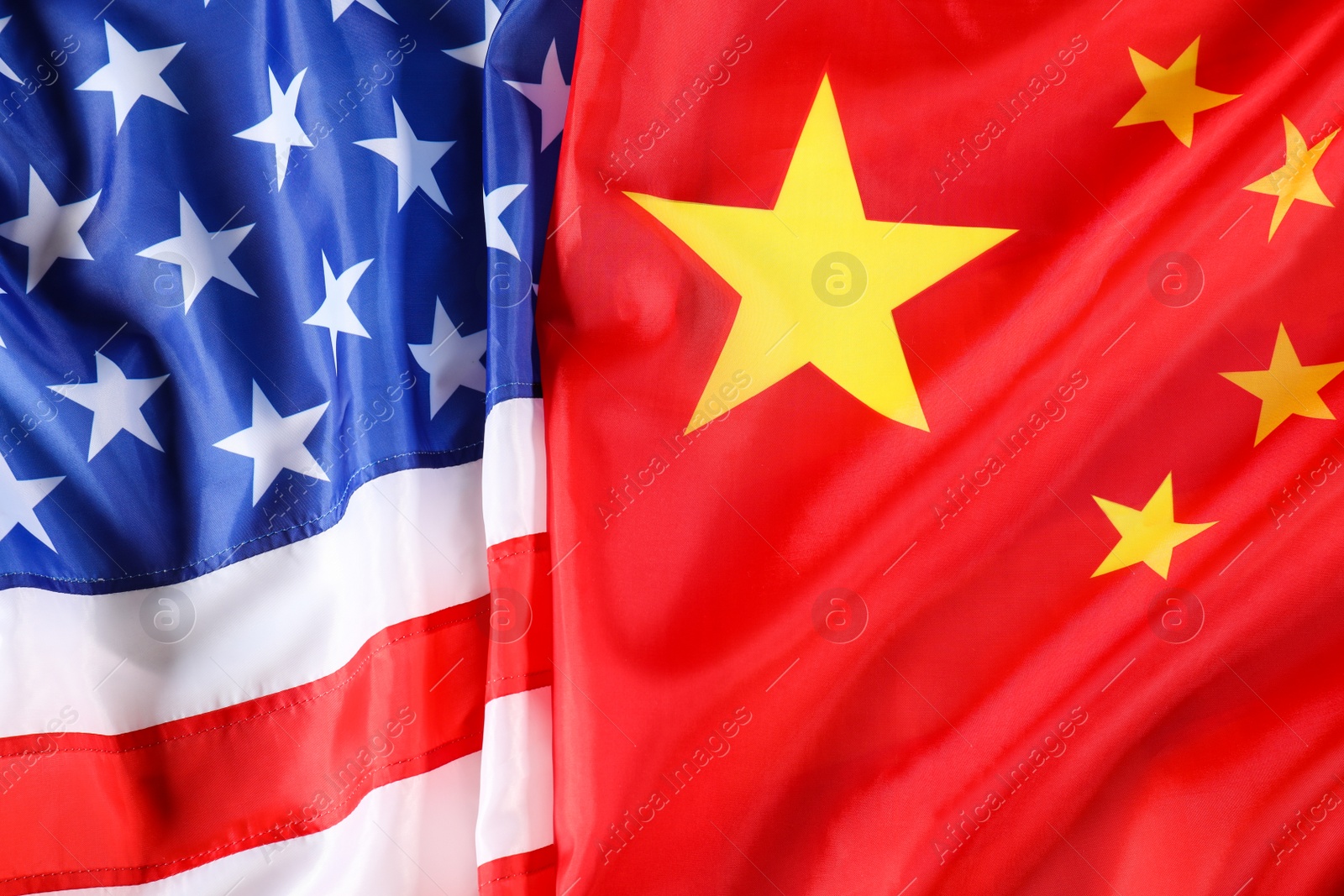 Photo of USA and China flags as background, top view. International relations