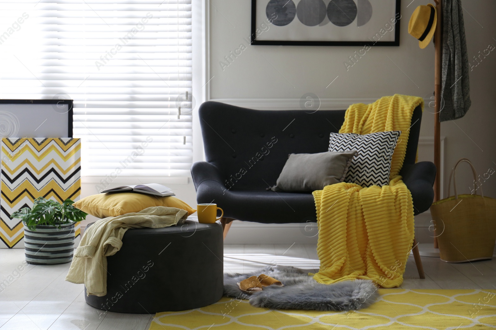 Photo of Comfortable sofa with pillows and plaid in living room. Interior design