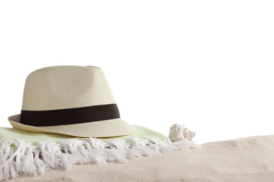 Photo of Folded towel, hat and shell on sand against white background. Beach objects