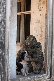 Photo of Ukrainian soldier with stray dog in abandoned building
