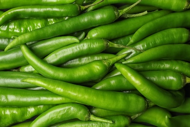 Photo of Ripe hot chili peppers as background, closeup