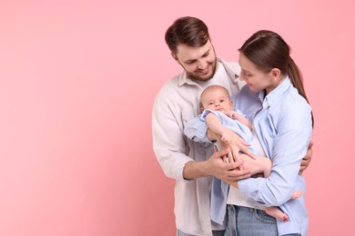 Happy family. Parents with their cute baby on pink background, space for text