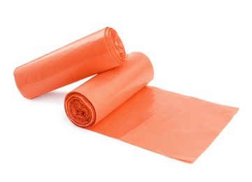 Photo of Rolls of orange garbage bags isolated on white