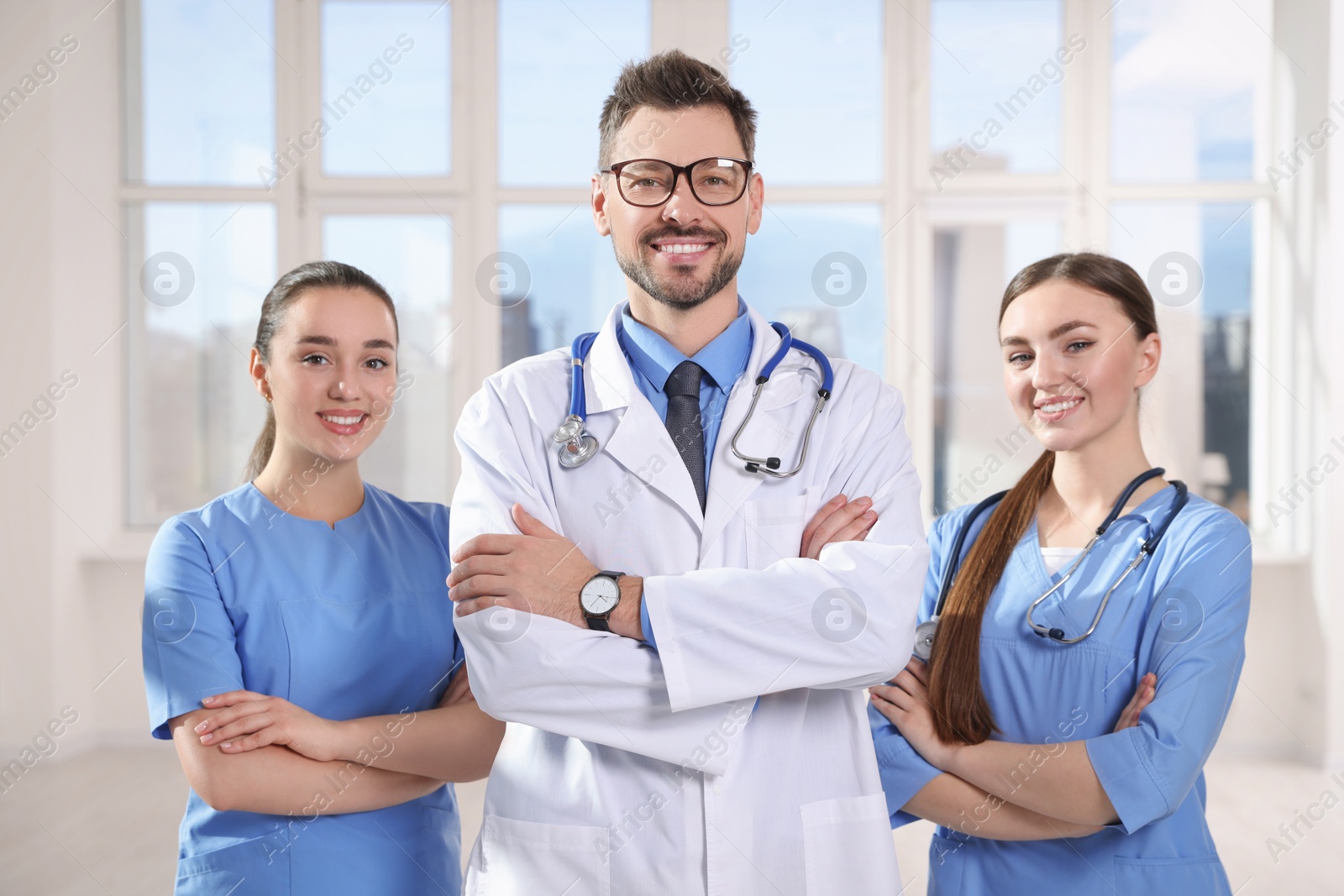 Photo of Team of professional doctors in clinic hallway