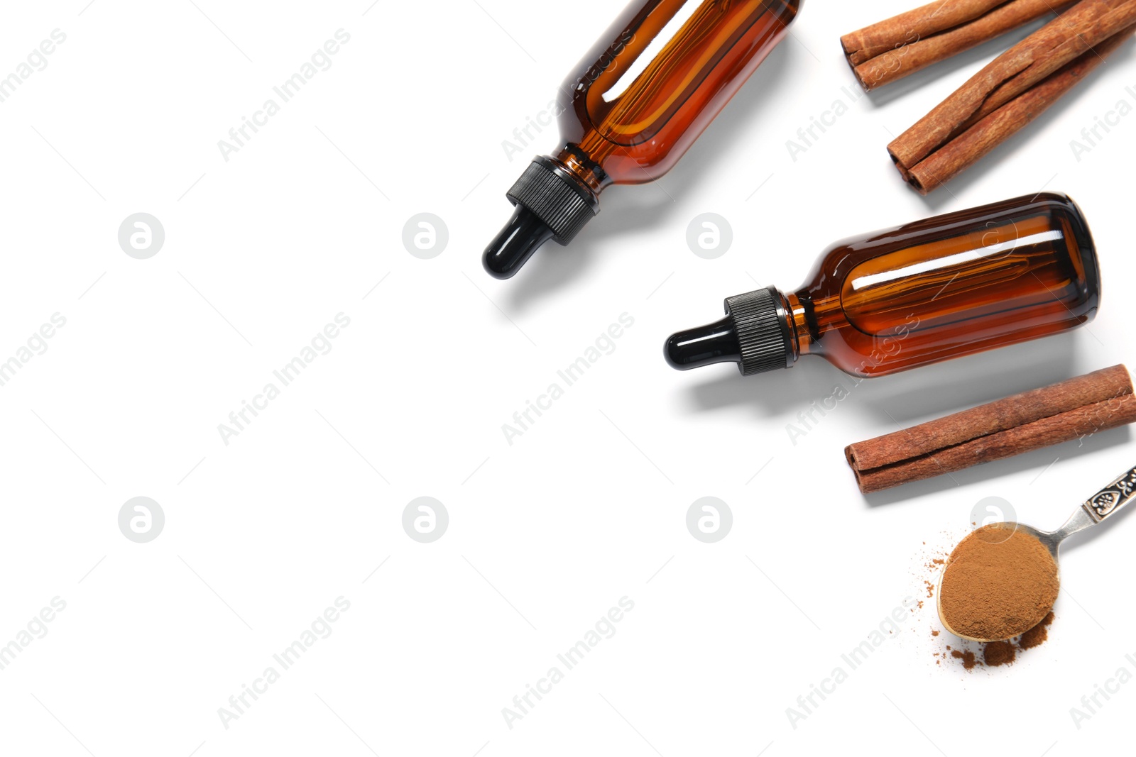 Photo of Flat lay composition with cinnamon essential oil on white background. Space for text