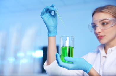 Photo of Female scientist working in chemistry laboratory, space for text