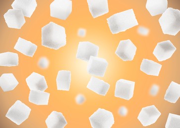 Refined sugar cubes in air on orange background