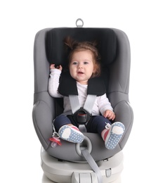 Photo of Adorable baby girl in child car safety seat on white background