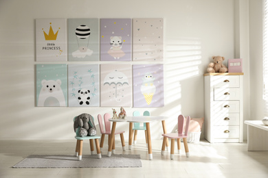 Small table and chairs with bunny ears in children's room interior