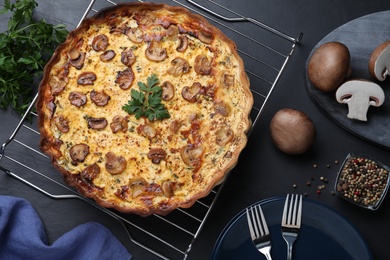 Flat lay composition with delicious homemade mushroom pie on black table