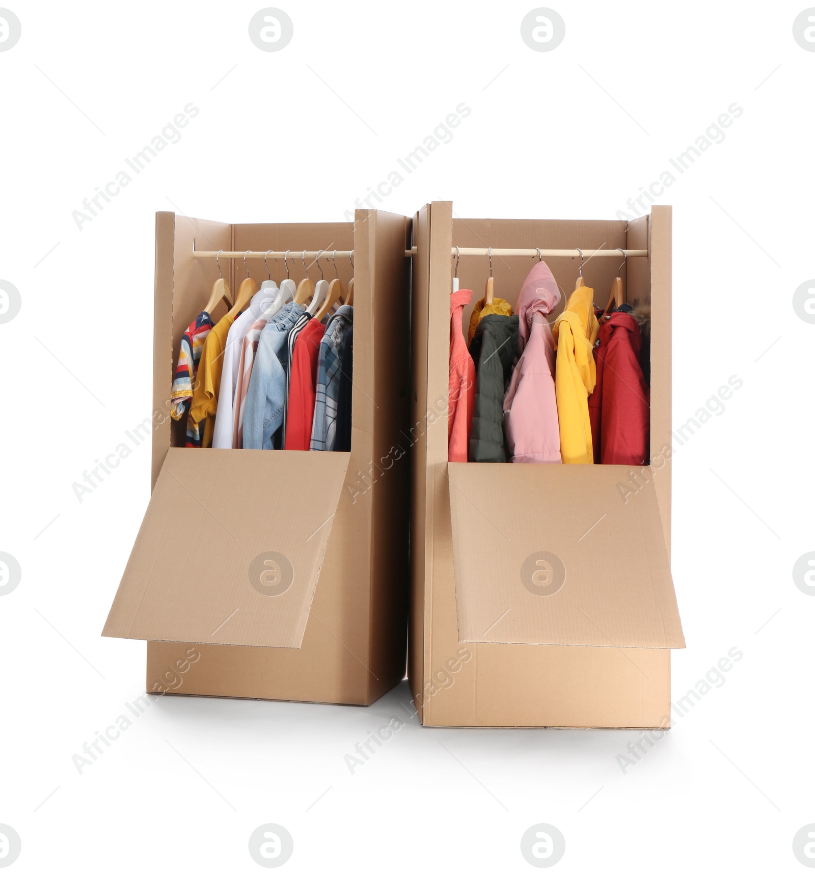 Photo of Cardboard wardrobe boxes with clothes on white background