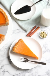 Flat lay composition with fresh delicious homemade pumpkin pie on marble background