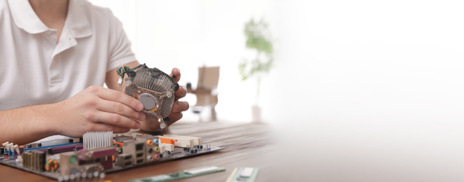 Image of Male technician repairing computer at table indoors, space for text. Banner design