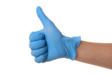 Photo of Person in blue latex gloves showing thumb up gesture against white background, closeup on hand