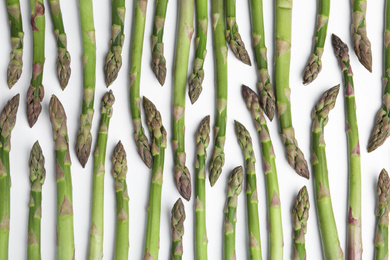 Photo of Fresh raw asparagus on white background, top view