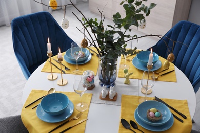 Beautiful Easter table setting with festive decor indoors, above view