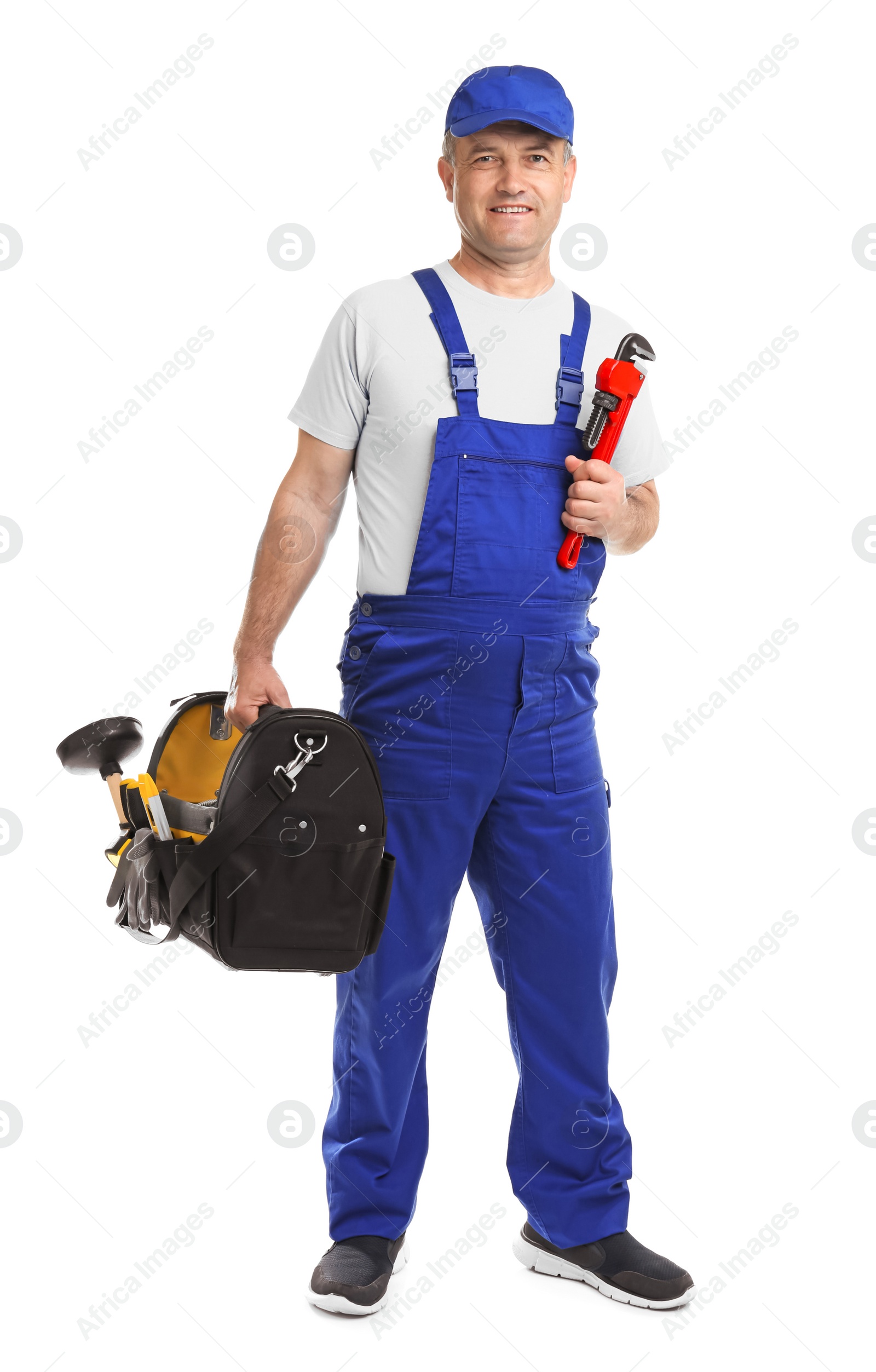 Photo of Mature plumber with pipe wrench and tool bag on white background