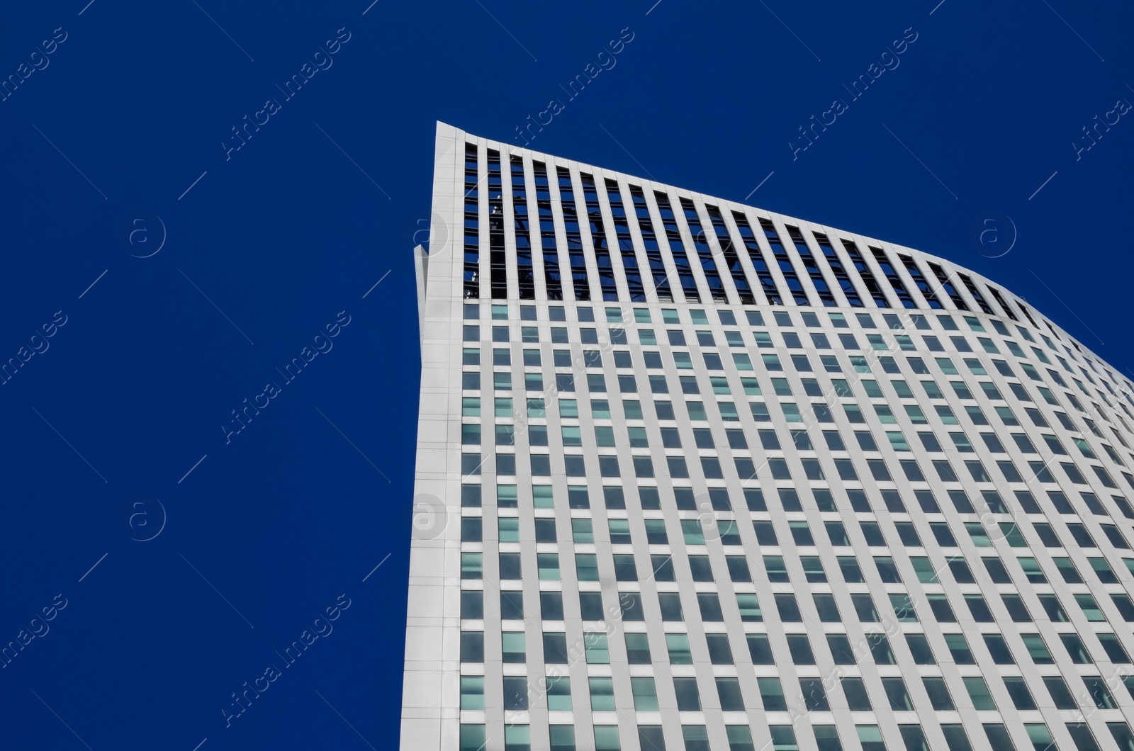 Photo of Exterior of beautiful modern building against blue sky, low angle view