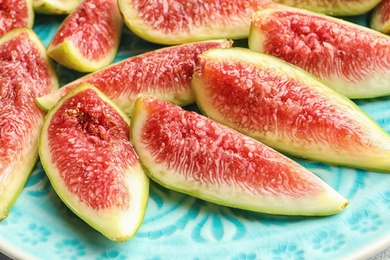 Fresh ripe fig slices on plate, closeup. Tropical fruit