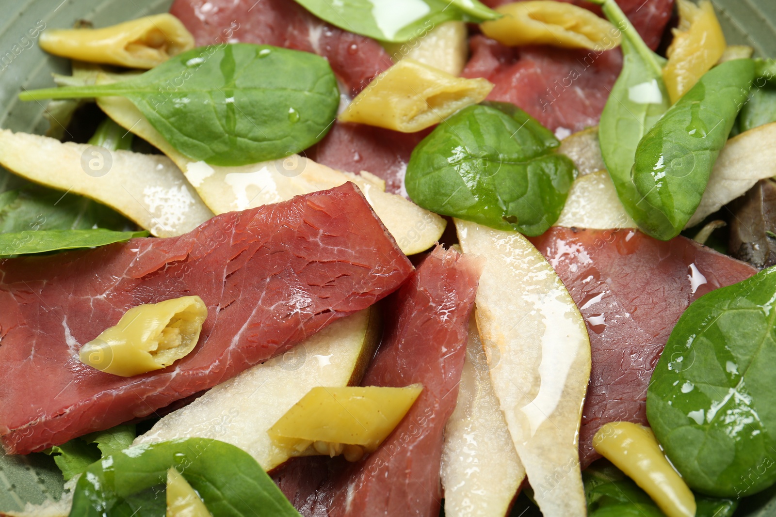 Photo of Delicious bresaola salad in bowl, closeup view