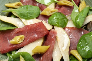 Delicious bresaola salad in bowl, closeup view