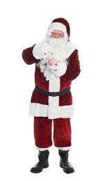 Photo of Santa Claus putting coin into piggy bank on white background
