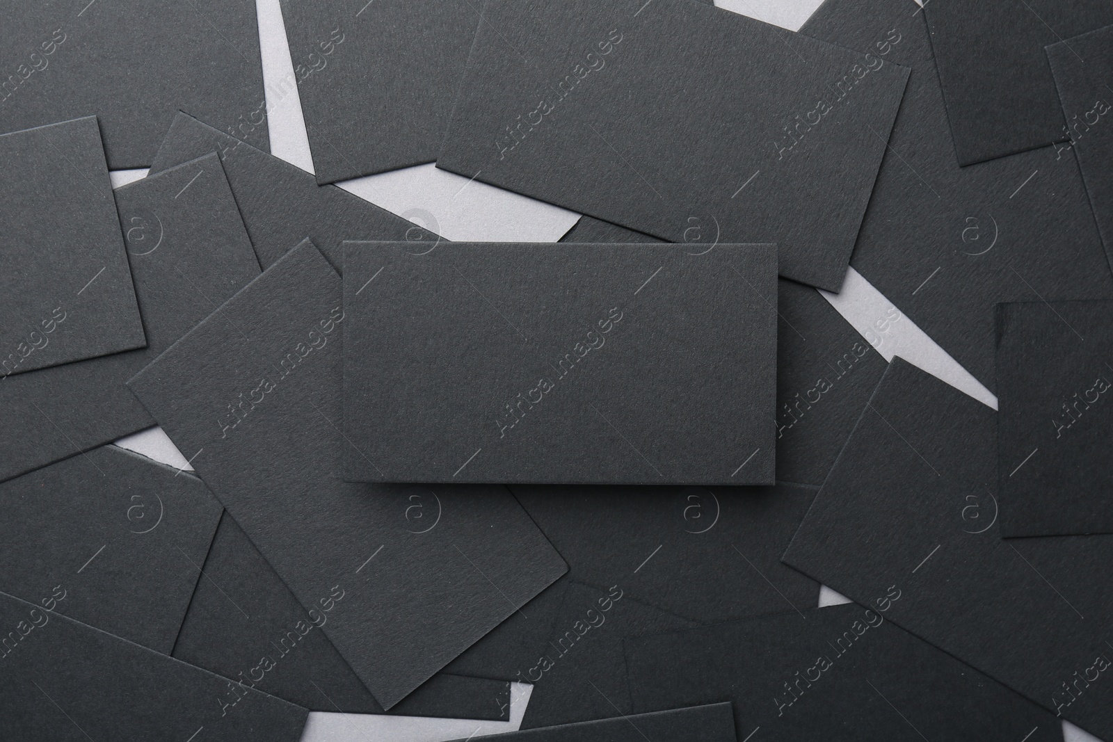 Photo of Blank black business cards on table, flat lay. Mockup for design