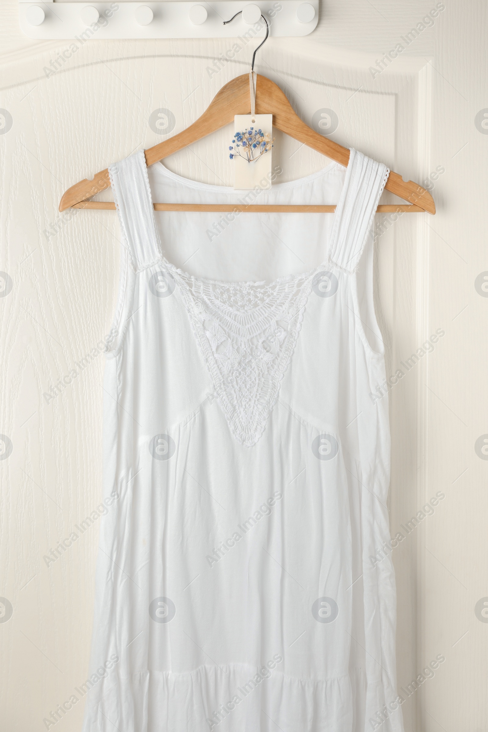 Photo of Scented sachet with flowers and stylish clothes on hanger