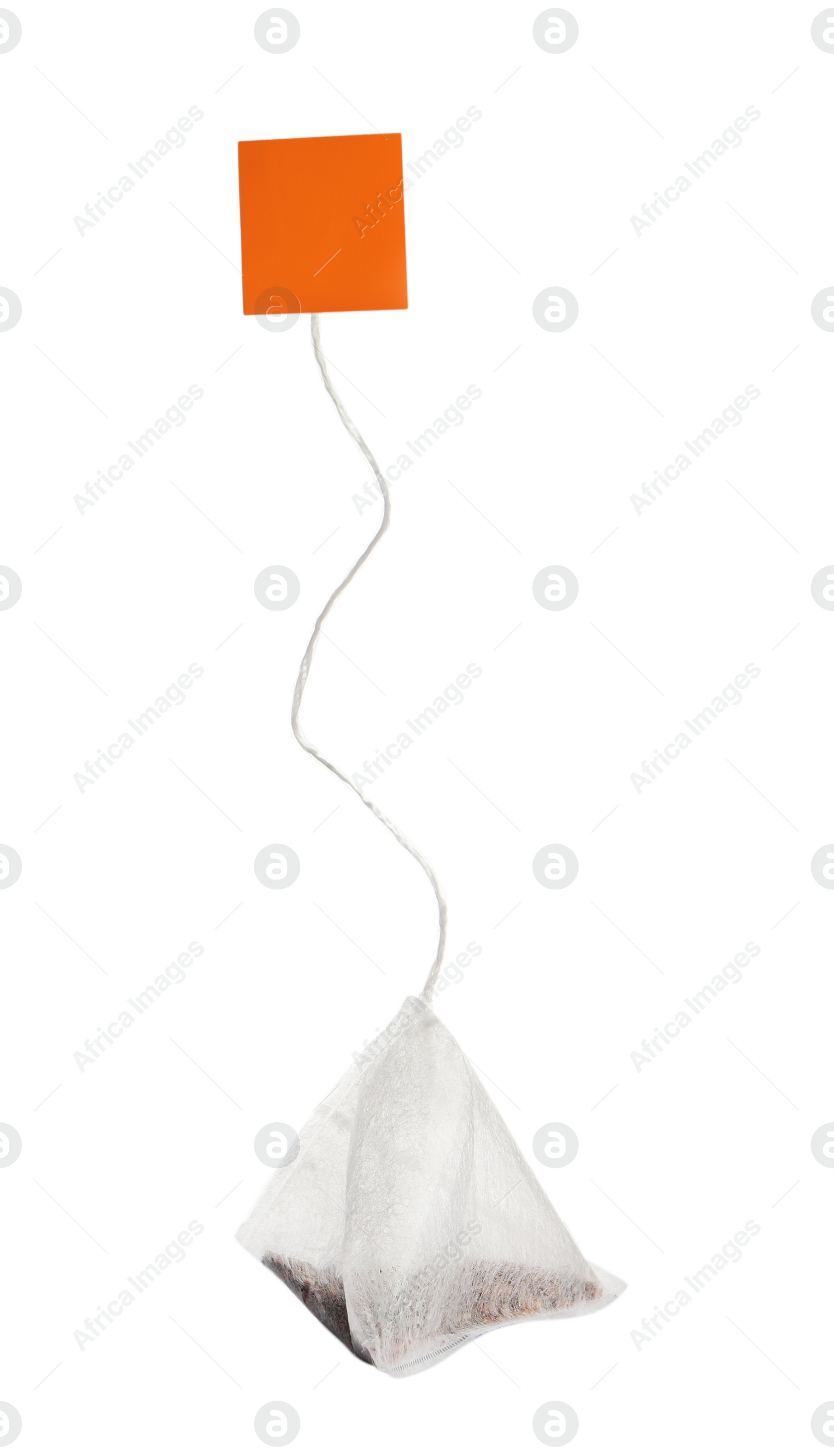 Photo of Paper tea bag with tag isolated on white