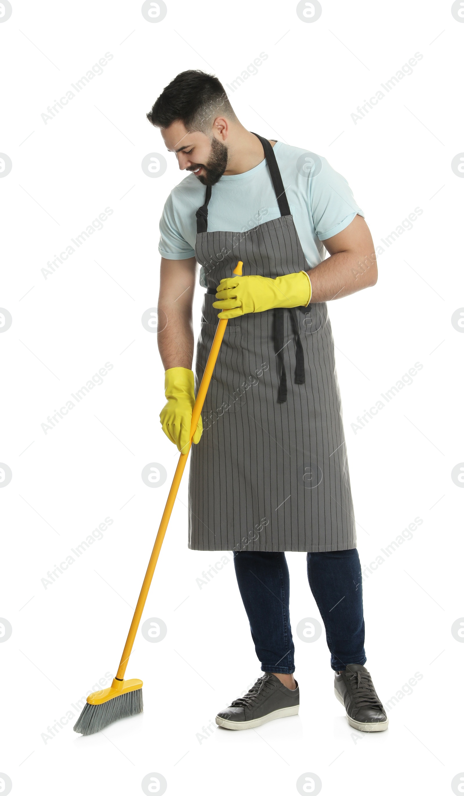 Photo of Young man with yellow broom on white background