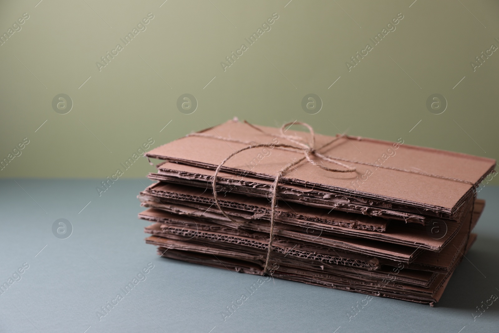 Photo of Stack of waste paper on grey table, space for text