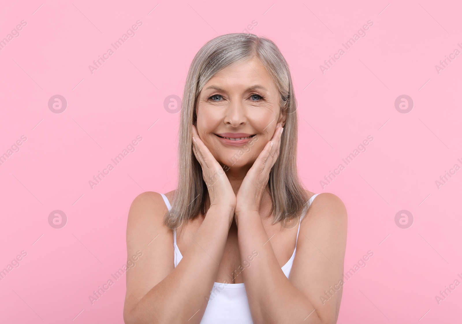 Photo of Portrait of beautiful senior woman on pink background