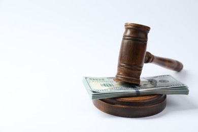 Photo of Law gavel with stack of dollars on white background. Space for text