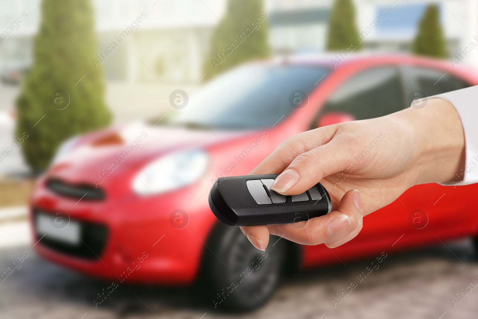 Image of Woman with key near new automobile outdoors, closeup