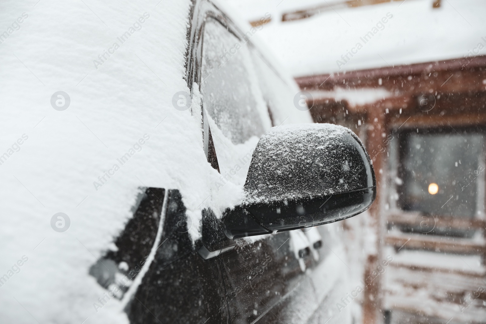 Photo of Modern car covered with snow outdoors on winter day, closeup