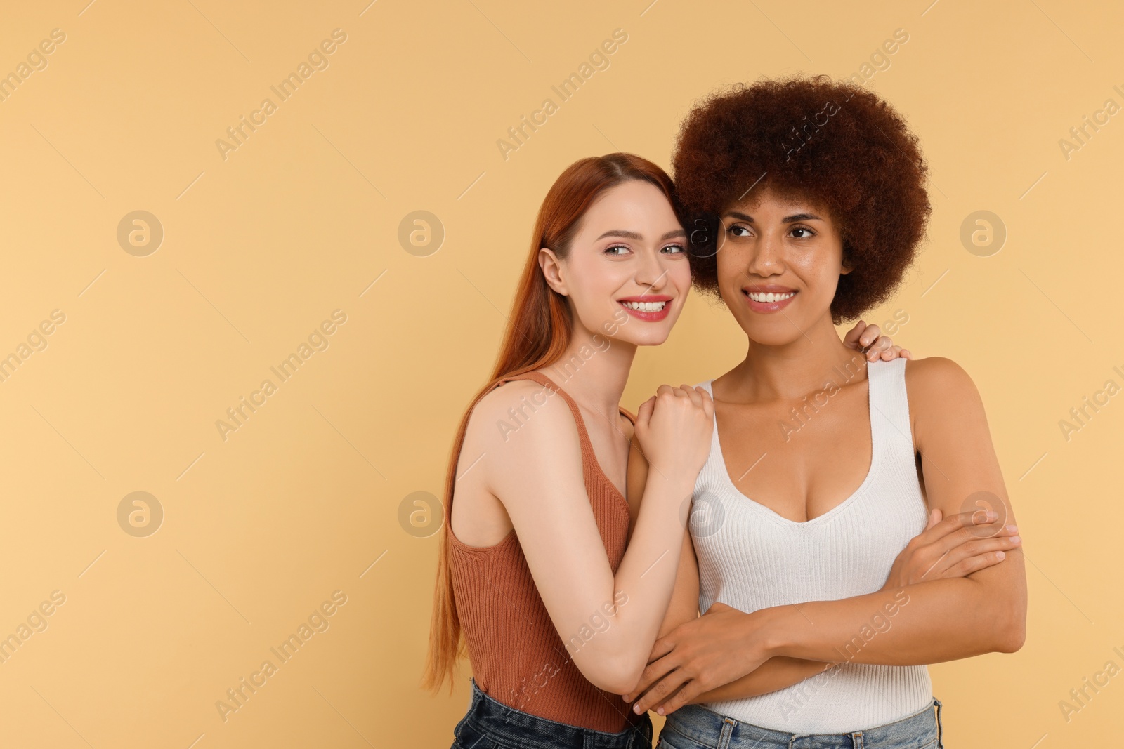 Photo of Portrait of beautiful young women on beige background. Space for text