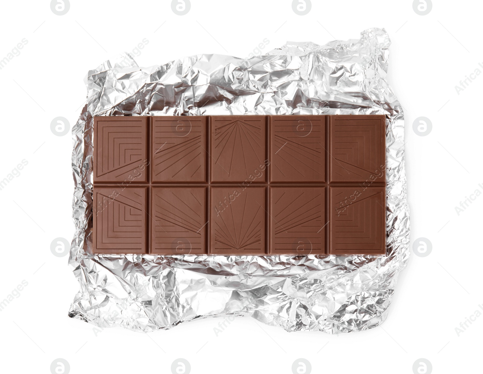 Photo of Delicious milk chocolate bar with foil isolated on white, top view