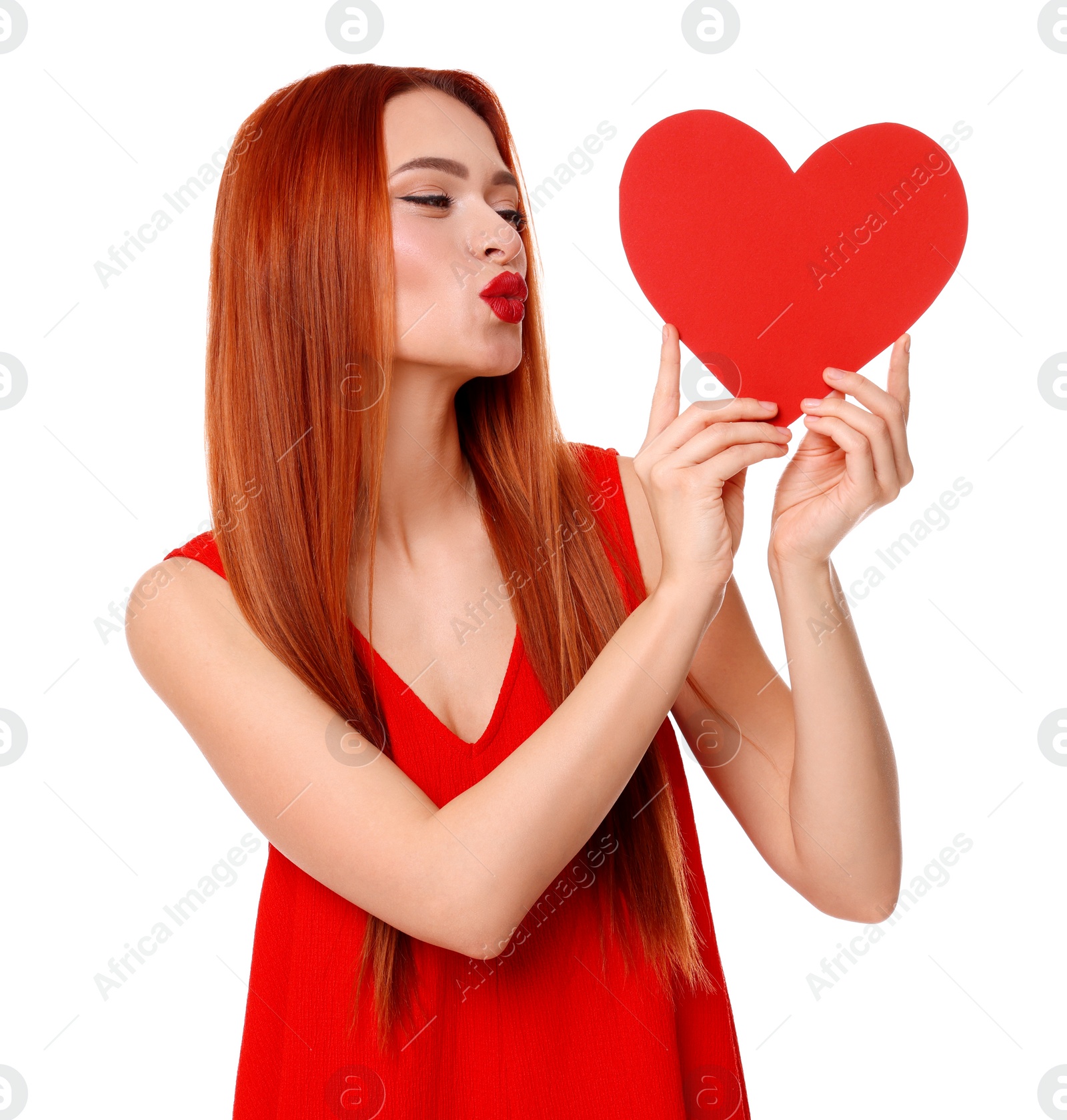 Photo of Young woman in red dress with paper heart on white background