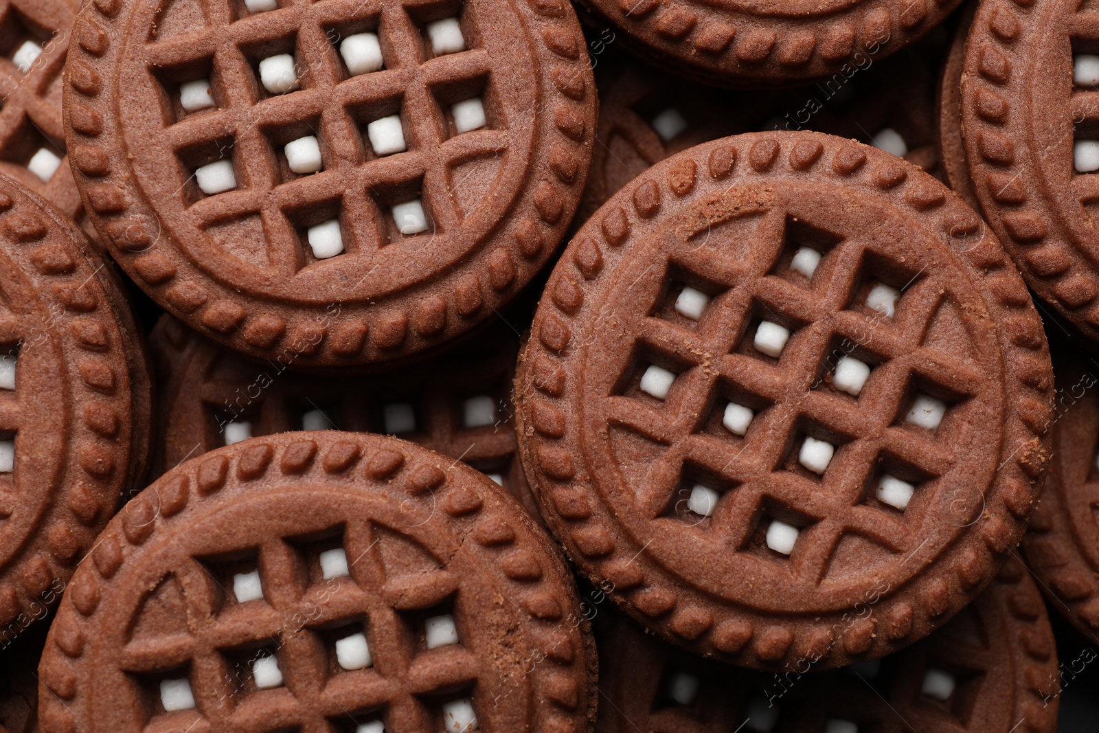 Photo of Tasty chocolate sandwich cookies with cream as background, top view