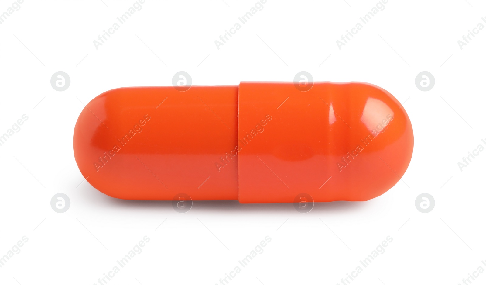 Photo of One orange pill on white background. Medicinal treatment