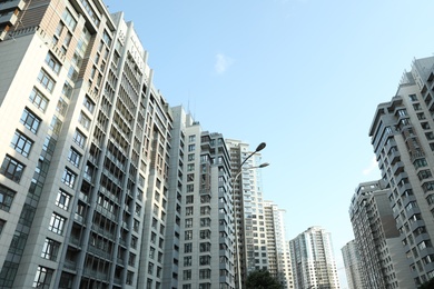 Photo of KYIV, UKRAINE - MAY 21, 2019: Beautiful view of modern housing estate in Pecherskyi district on sunny day, low angle