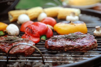 Barbecue grill with tasty fresh food outdoors, closeup
