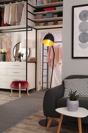 Photo of Modern wardrobe room interior with stylish furniture