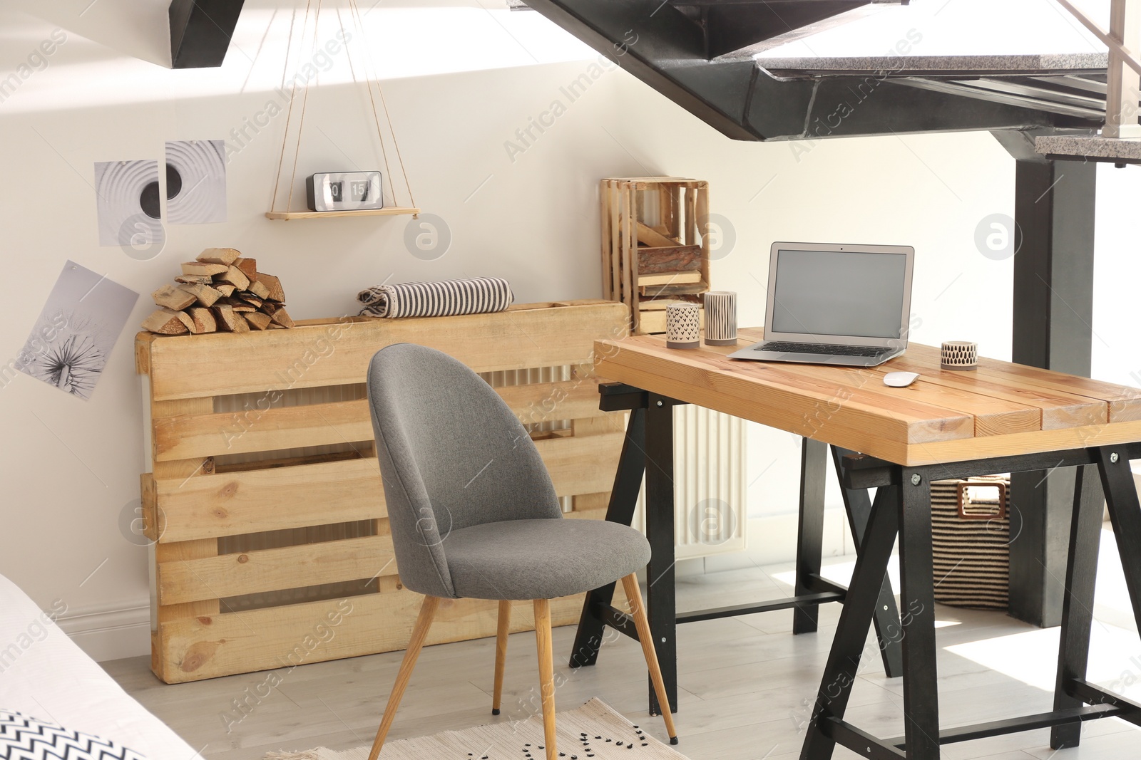 Photo of Elegant interior of room with workplace under stairs