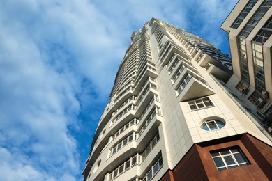 KYIV, UKRAINE - MAY 23, 2019: Modern dwelling building against sky with clouds