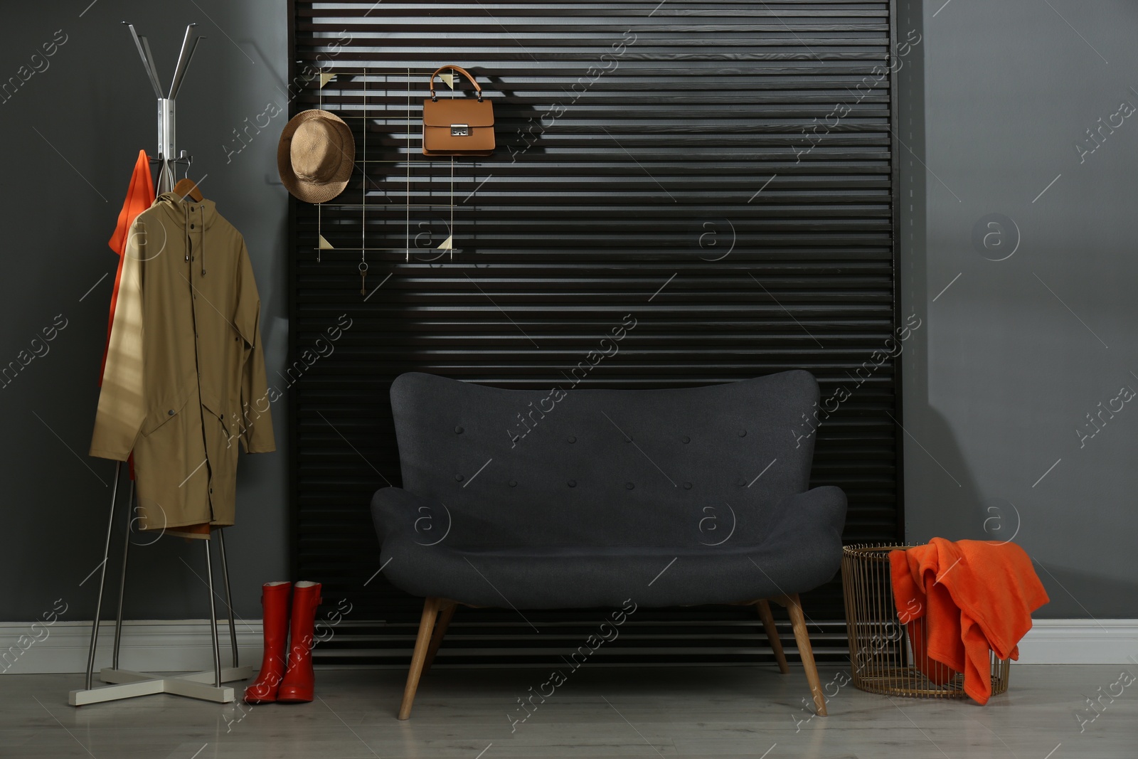 Photo of Hallway interior with sofa, clothes and accessories