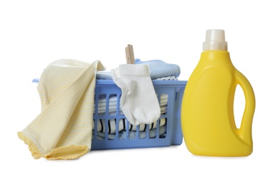 Basket with fresh baby laundry and bottle of detergent on white background