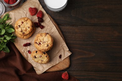 Photo of Cookies with freeze dried fruits and mint on wooden table, flat lay. Space for text