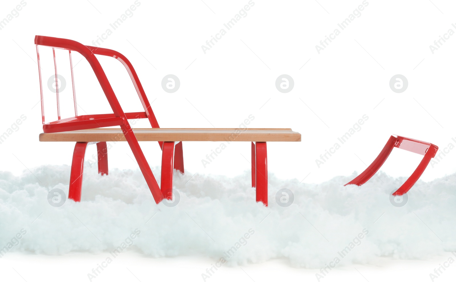 Photo of Sleigh and artificial snow on white background. Winter outdoor activity